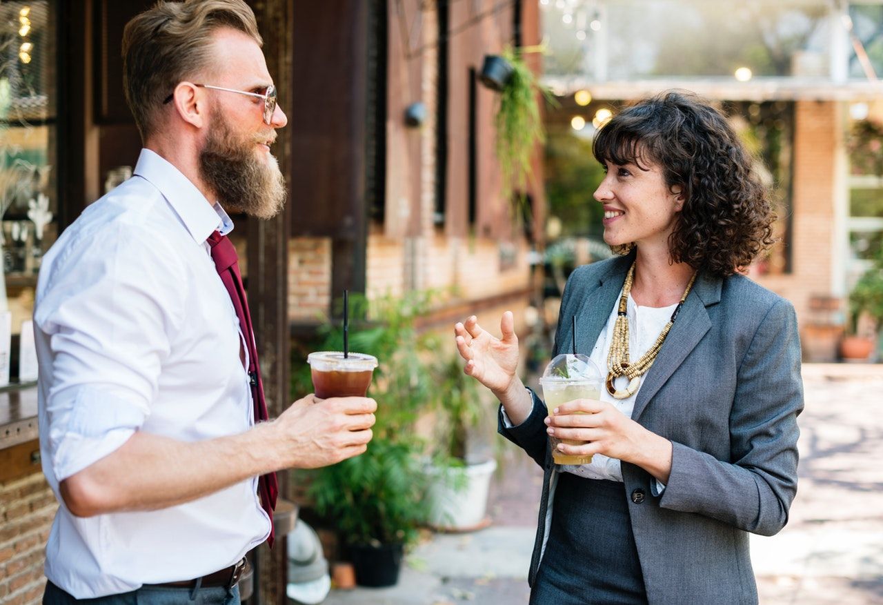 Two people communicating outside